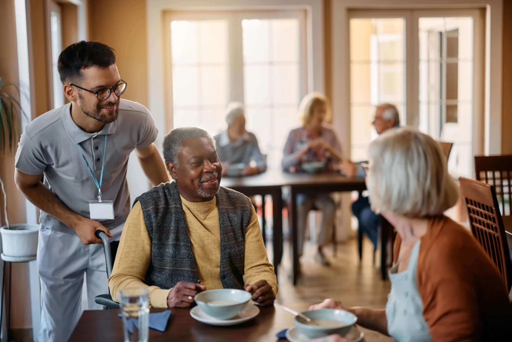 Adult assisted living care giver at table