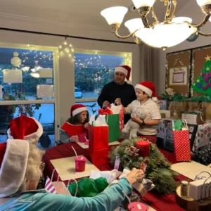 Olimpia Senior Care Christmas Party Passing Out Gifts To Residents